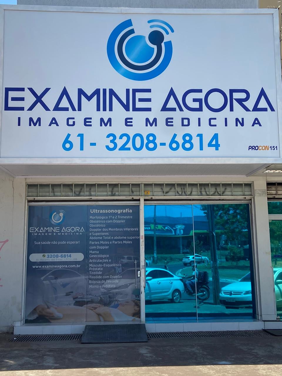 Fachada da Examine Agora na Av. Recanto das Emas, com a placa da clínica e o telefone (61) 3208-6814